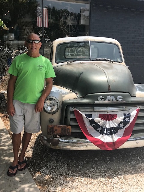 Homer Terry Standing by a old truck