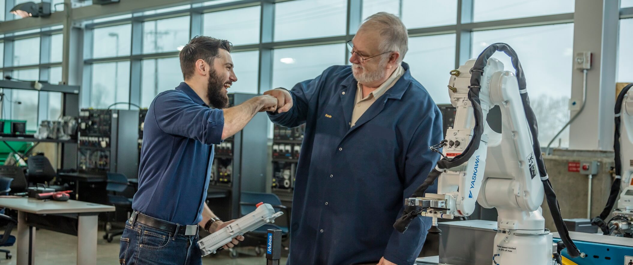 teacher fist bumping student